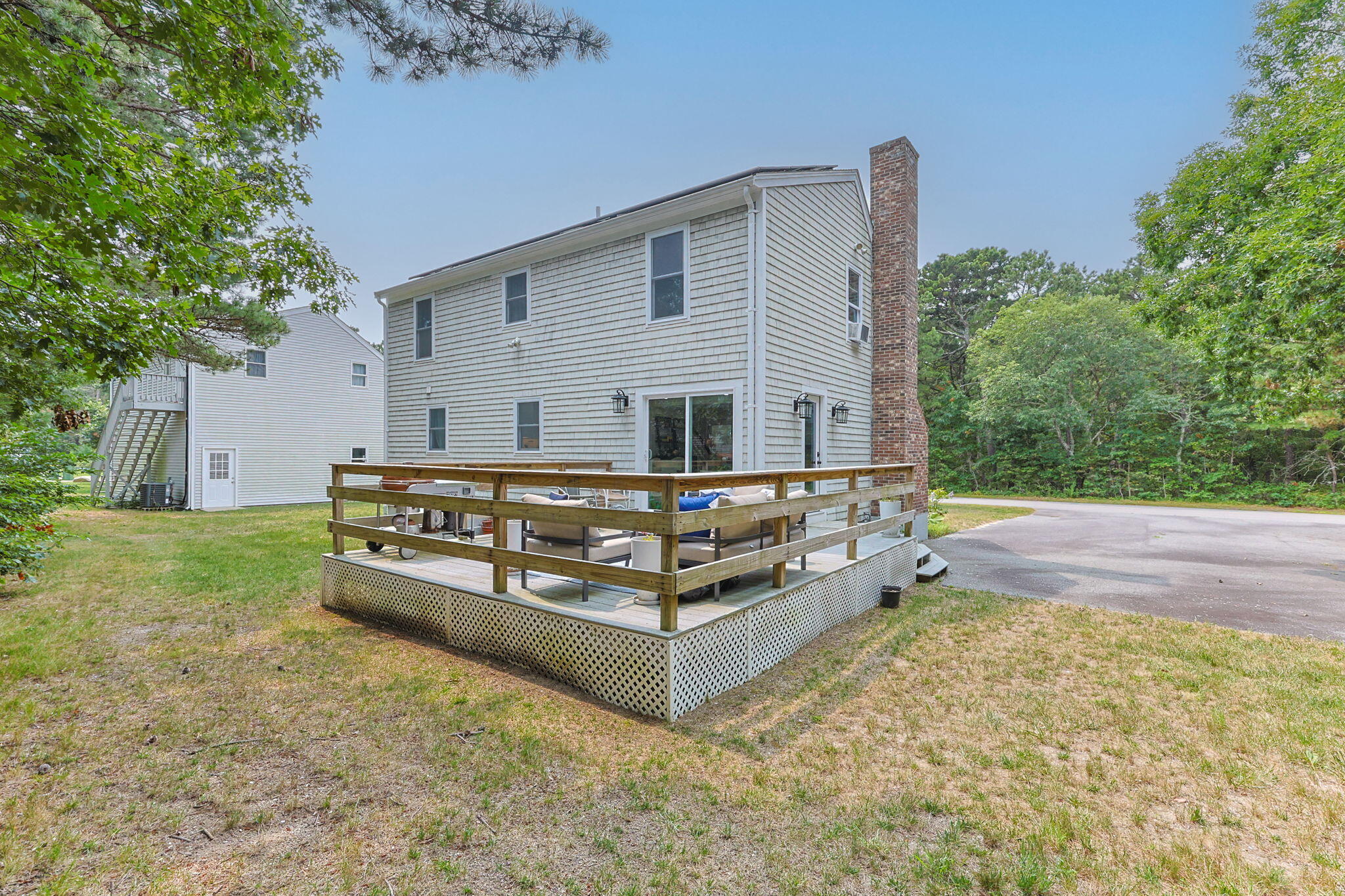 140 Noisy Hole Road Mashpee, MA 02649 - Photo 37 of 53 a view of backyard with deck and outdoor seating