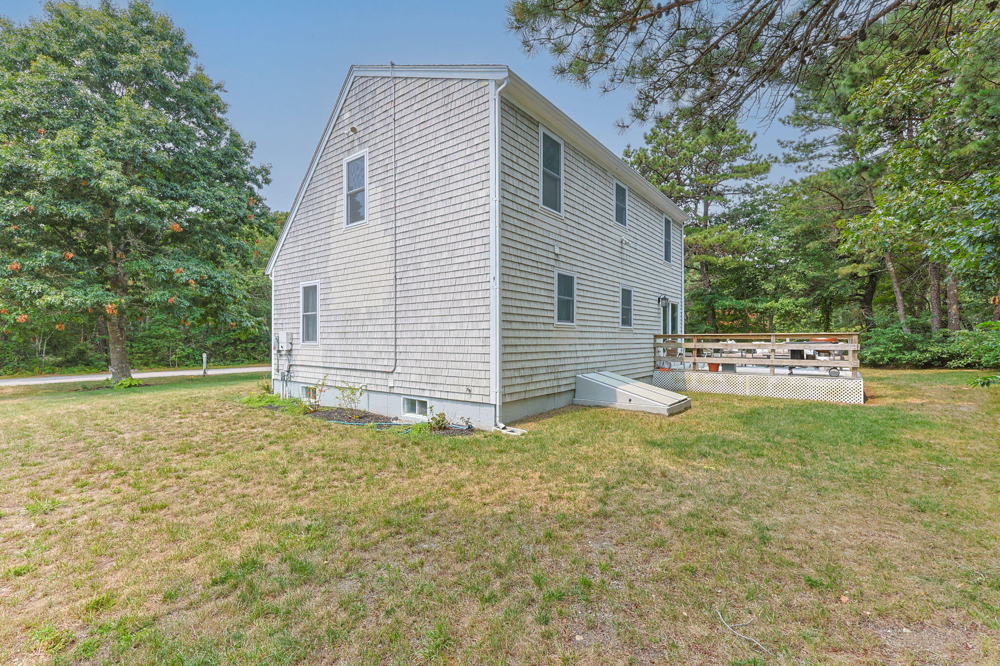 140 Noisy Hole Road Mashpee, MA 02649 - Photo 38 of 53 a view of backyard of house with trees