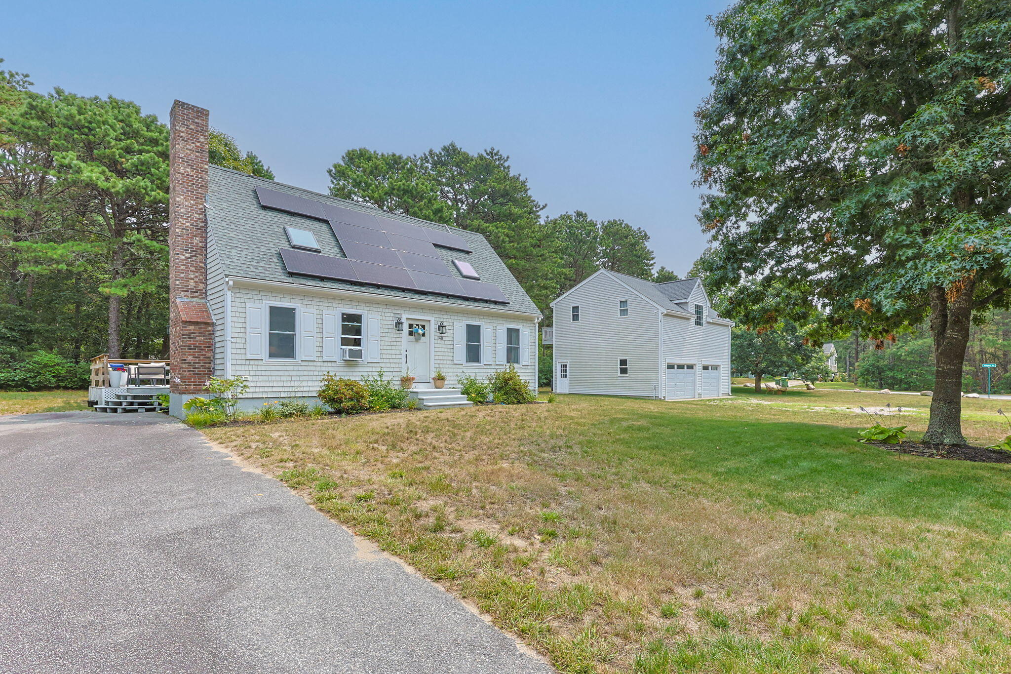140 Noisy Hole Road Mashpee, MA 02649 - Photo 47 of 53 a front view of a house with a yard and garage