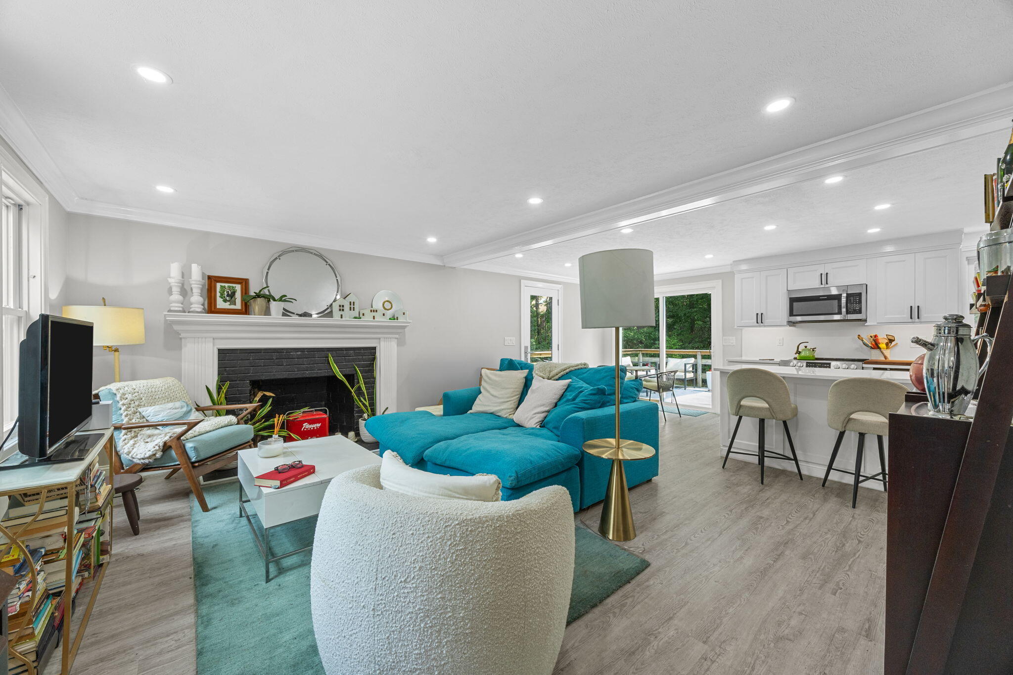 140 Noisy Hole Road Mashpee, MA 02649 - Photo 6 of 53 a living room with furniture a fireplace and kitchen view