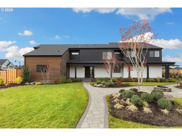 a view of a house with swimming pool and a yard