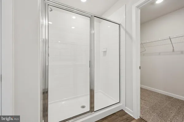 a bathroom with a glass shower door