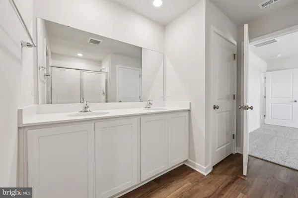 a bathroom with a double vanity sink and mirror