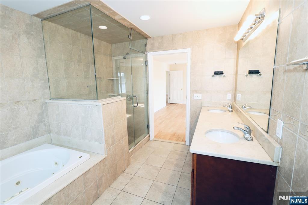 23 Main Avenue Wallington, NJ 07057 - Photo 18 of 29 a bathroom with a tub sink and a mirror