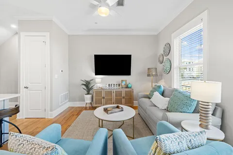 a kitchen with stainless steel appliances granite countertop a refrigerator a stove a sink a dining table and chairs with wooden floor