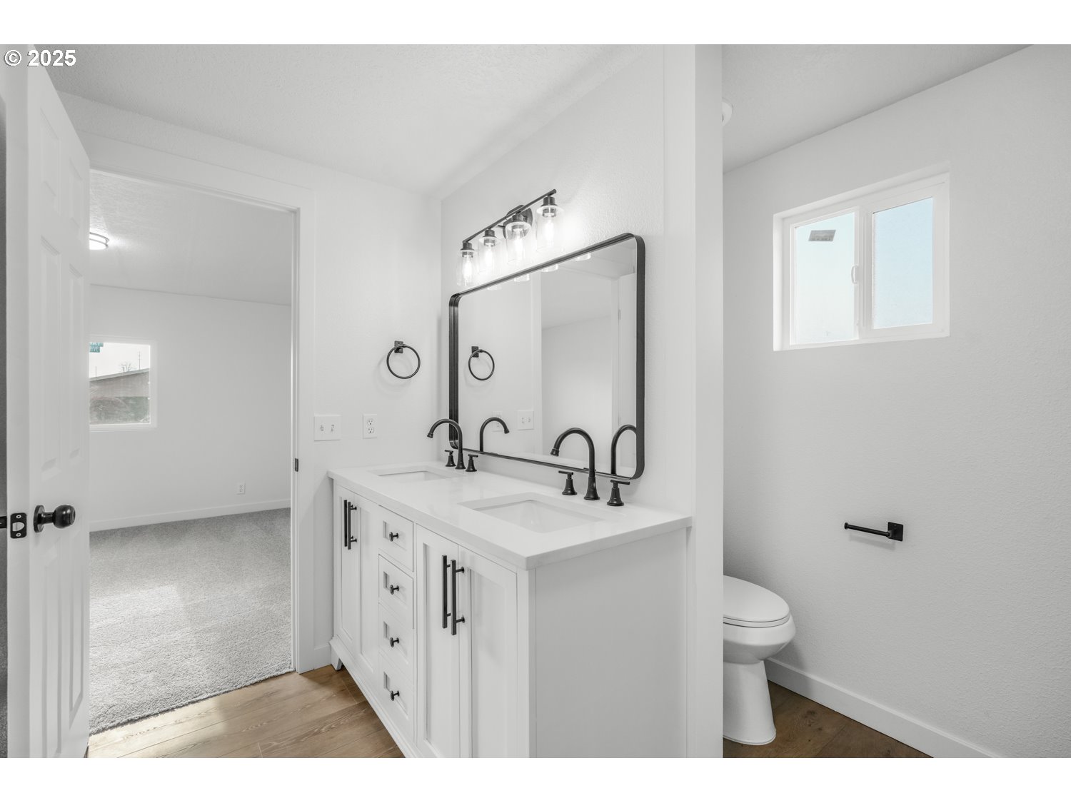 871 Liberty Bell Drive, Unit 474 Beaverton, OR 97006 - Photo 14 of 26 a bathroom with a sink a toilet and mirror