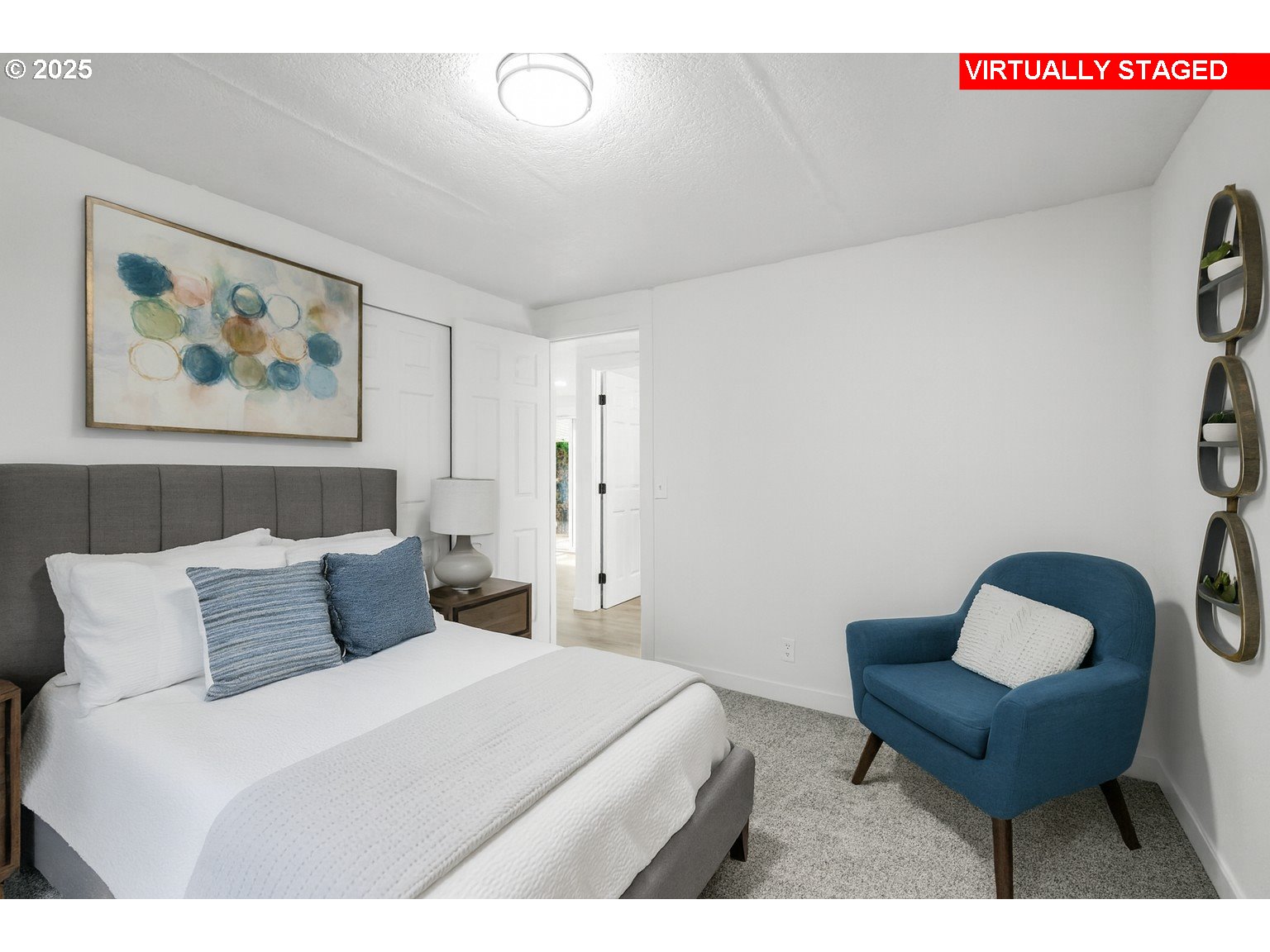 871 Liberty Bell Drive, Unit 474 Beaverton, OR 97006 - Photo 16 of 26 a bedroom with a bed and a chair