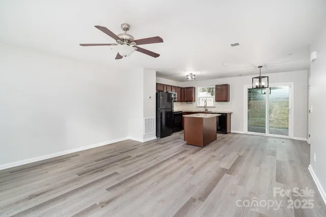 a kitchen with stainless steel appliances a refrigerator and a stove top oven