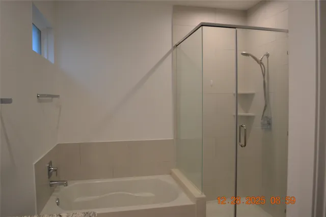 a bathroom with a bathtub and shower