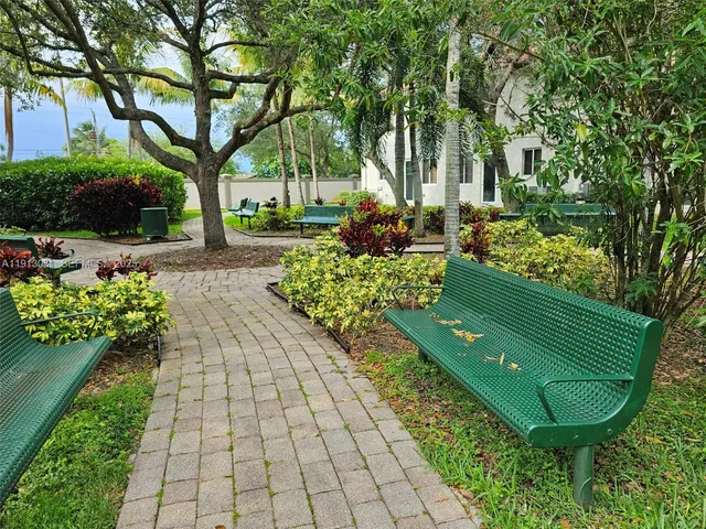 a view of a garden with flowers and trees