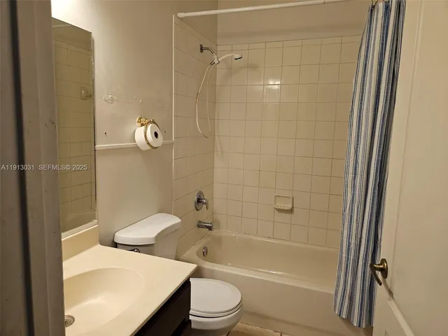 a bathroom with a granite countertop toilet a sink and shower