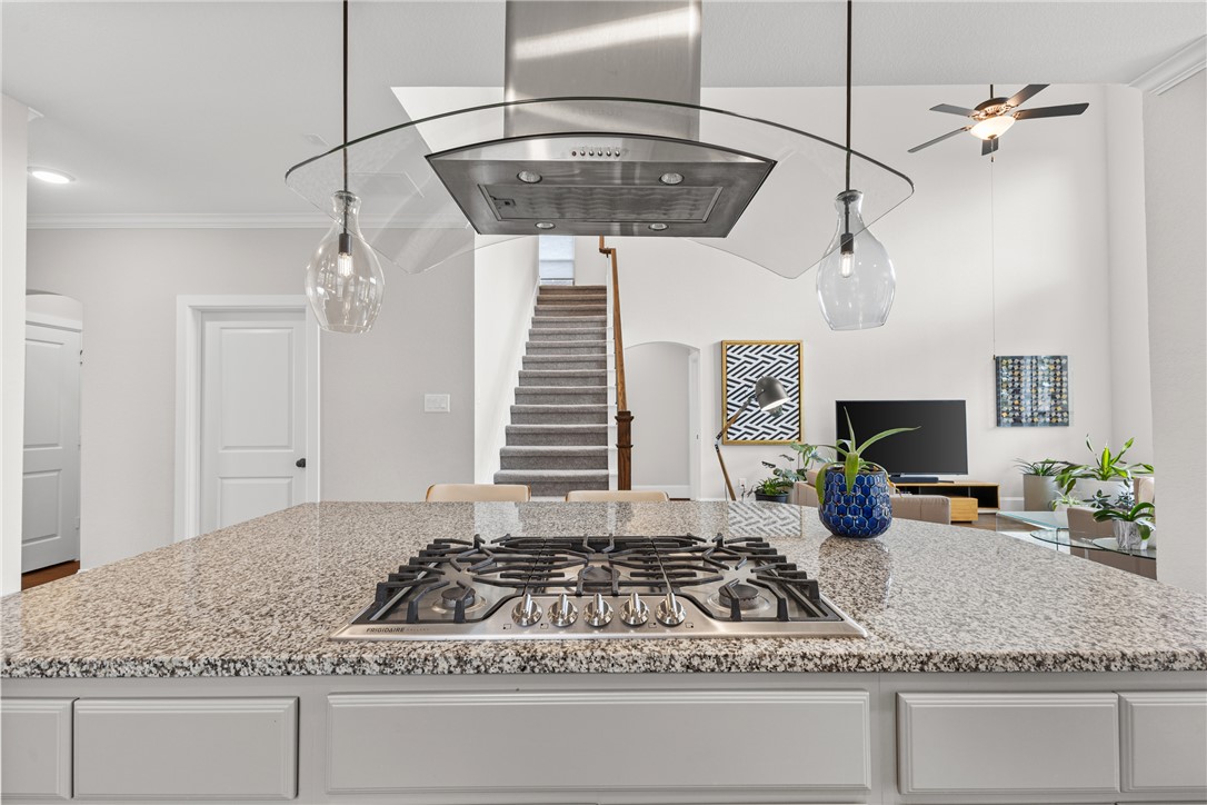 3632 Haskell Hollow Loop College Station, TX 77845 - Photo 11 of 42 a kitchen with kitchen island granite countertop a stove and a white counter top