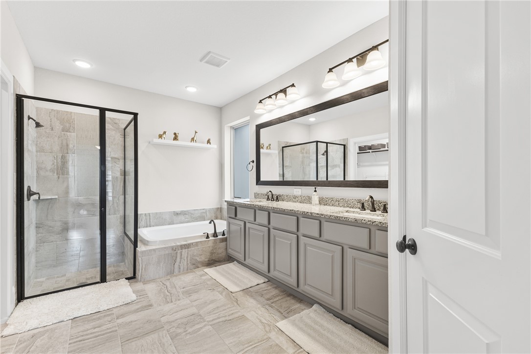 3632 Haskell Hollow Loop College Station, TX 77845 - Photo 18 of 42 Full bath featuring a stall shower, a bath, and double vanity
