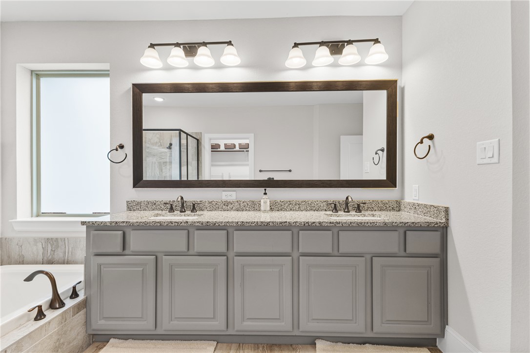 3632 Haskell Hollow Loop College Station, TX 77845 - Photo 19 of 42 a bathroom with a granite countertop sink vanity and mirror