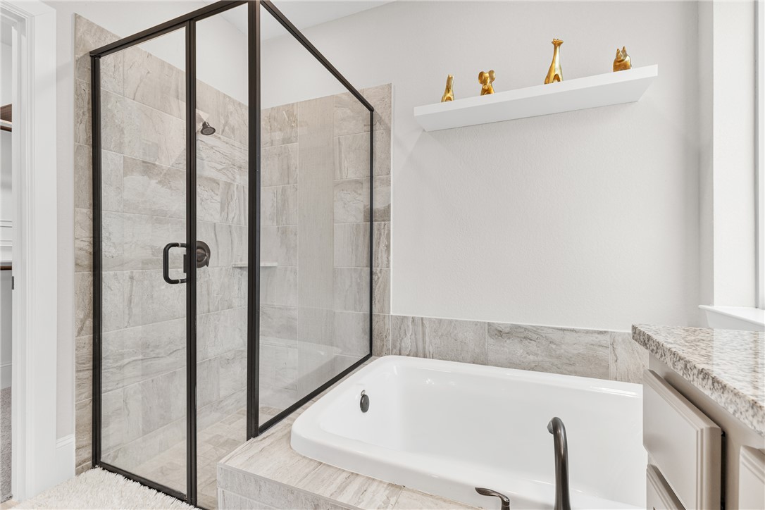 3632 Haskell Hollow Loop College Station, TX 77845 - Photo 20 of 42 a bathroom with a tub and a shower