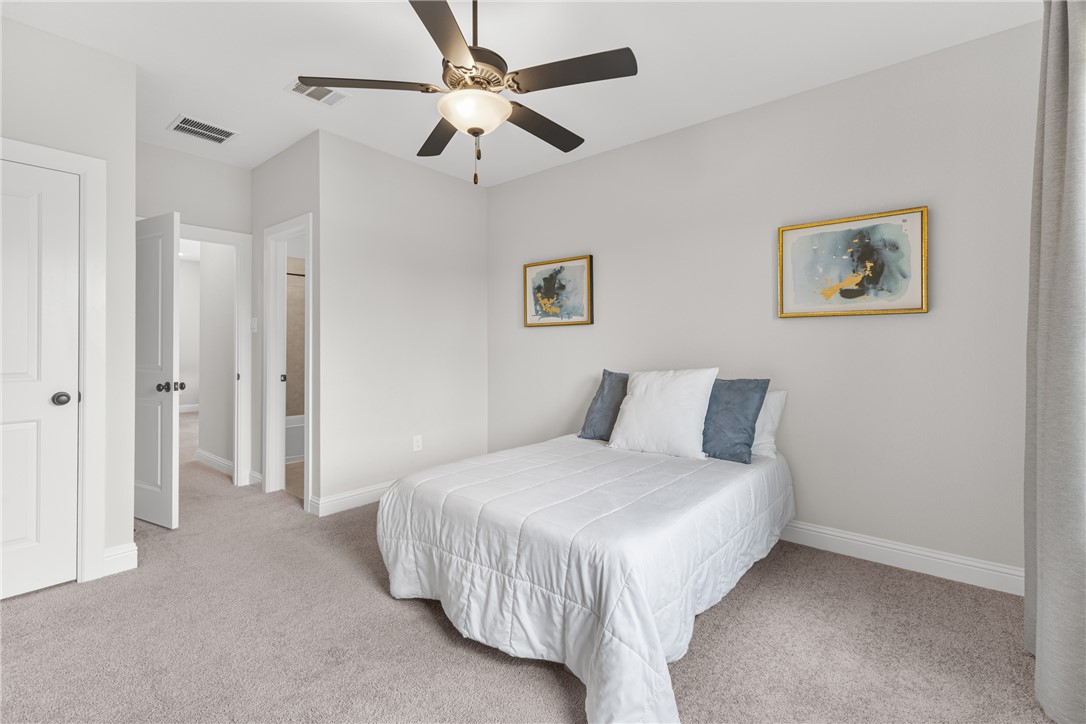 3632 Haskell Hollow Loop College Station, TX 77845 - Photo 24 of 42 a bedroom with a bed and a ceiling fan