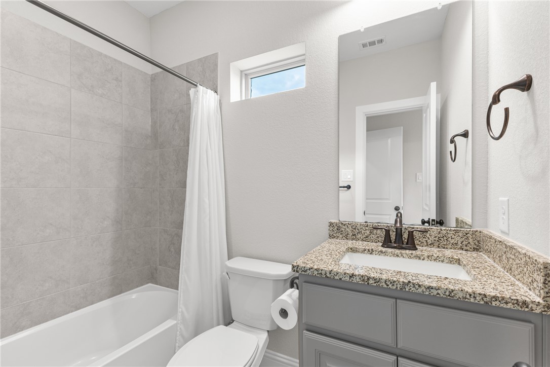 3632 Haskell Hollow Loop College Station, TX 77845 - Photo 25 of 42 a bathroom with a granite countertop sink toilet and shower