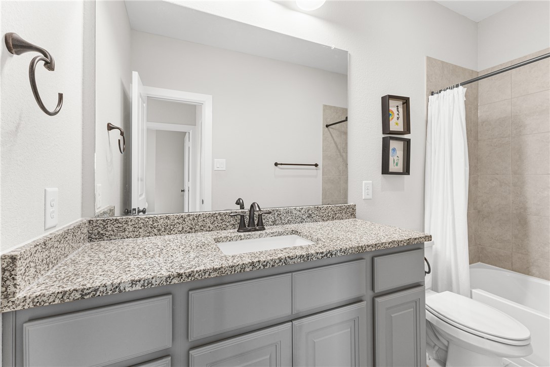 3632 Haskell Hollow Loop College Station, TX 77845 - Photo 28 of 42 a bathroom with a granite countertop sink and a mirror