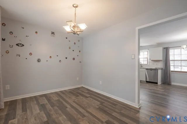 a view of a room with wooden floor and a large window
