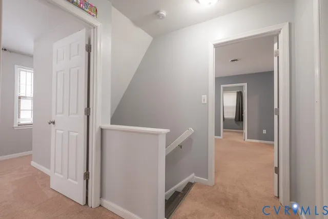 a view of a hallway with an entryway door