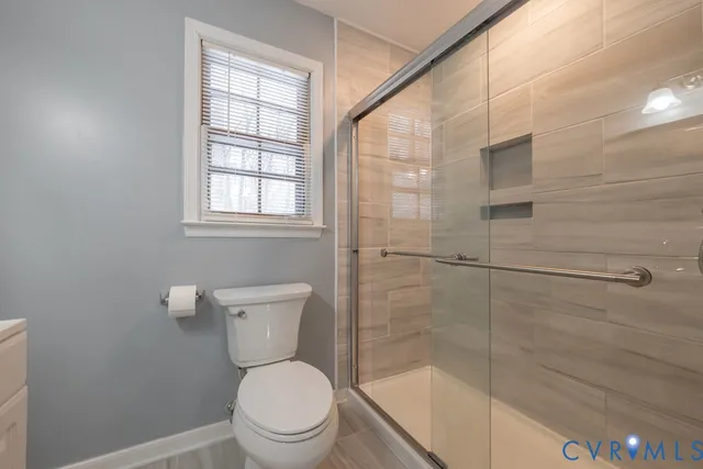 a bathroom with a toilet and shower