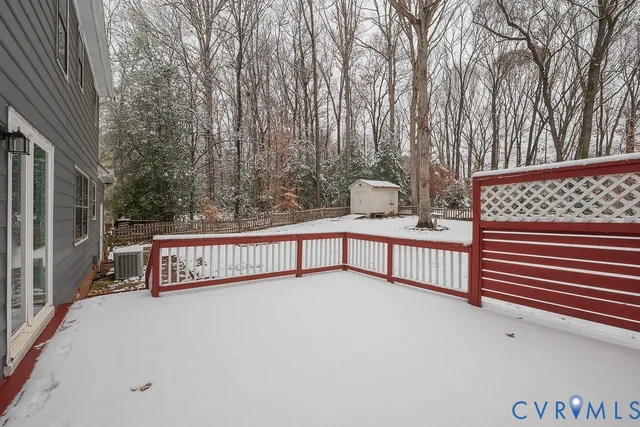 a view of staircase with large trees and wooden fence