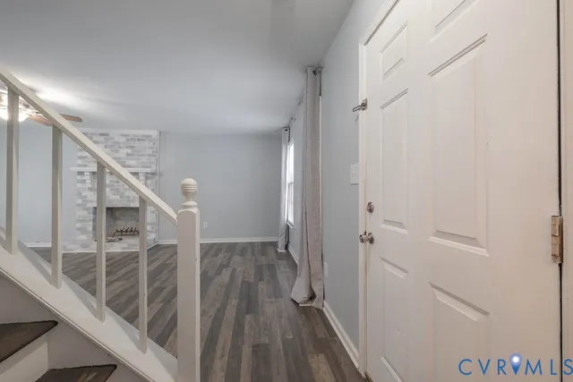 a view of a hallway with wooden floor and entryway