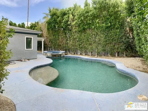 a view of a swimming pool with a yard