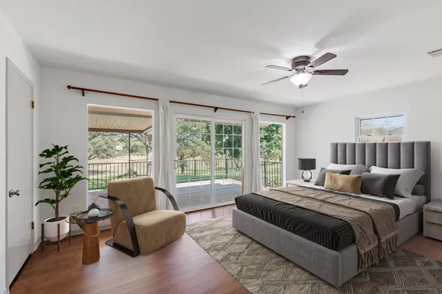 a spacious bedroom with a bed couch and a large window