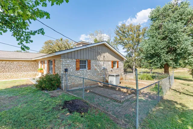 a view of house with backyard and garden