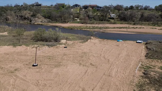 a view of swimming pool with a yard and lake view