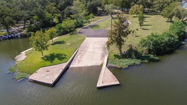 an aerial view of a house with swimming pool and lake view