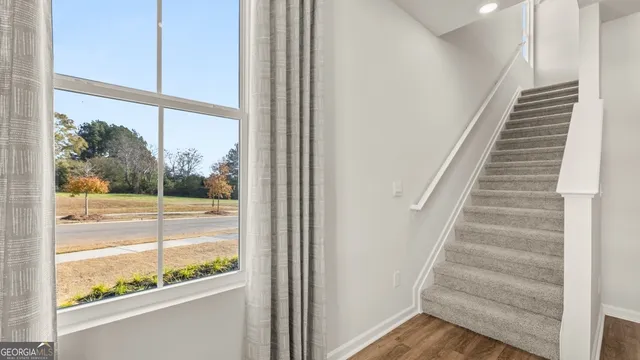 a bedroom with a bed and a lamp on dresser