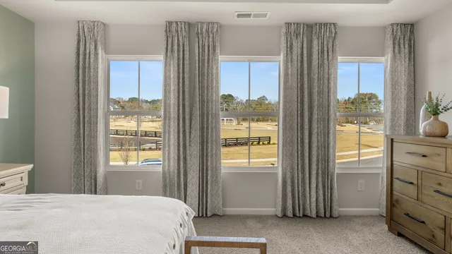 a view of a house with backyard and trees