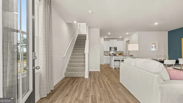 a view of a kitchen with cabinets stainless steel appliances and a window