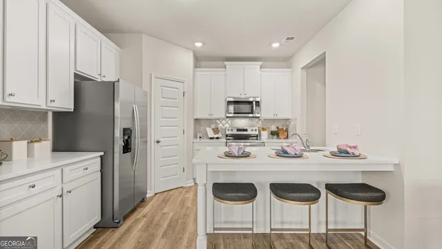 a kitchen with stainless steel appliances a sink a stove and microwave