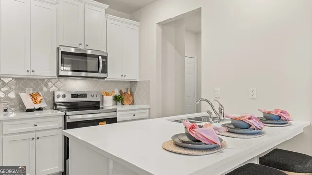 a kitchen with stainless steel appliances kitchen island granite countertop a sink and cabinets