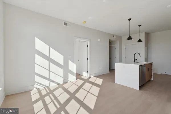 a view of a kitchen with wooden floor and a sink