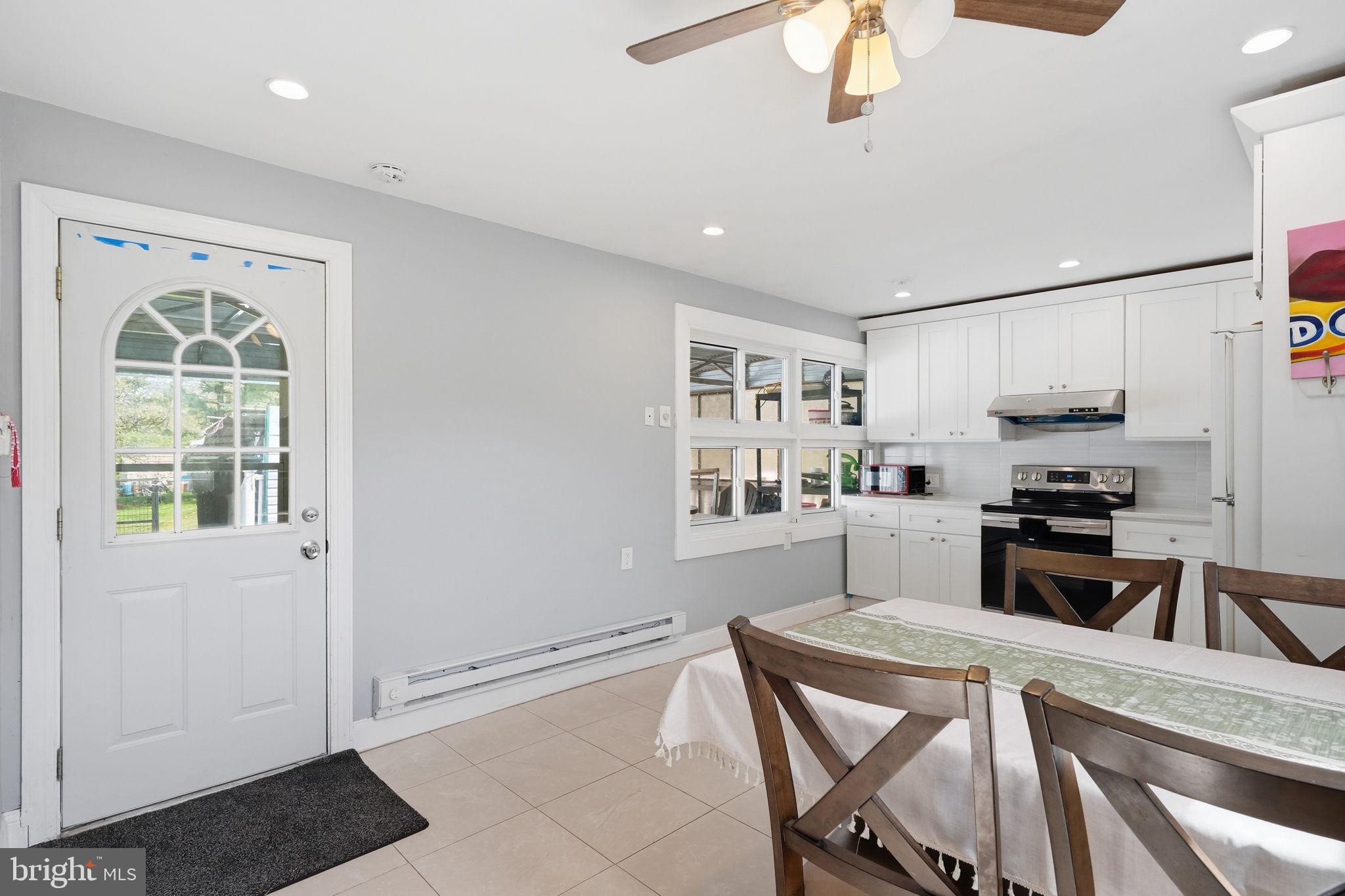 632 Durham Road Newtown, PA 18940 - Photo 3 of 37 a kitchen with stainless steel appliances granite countertop a stove a refrigerator a sink a microwave oven with a dining table and chairs
