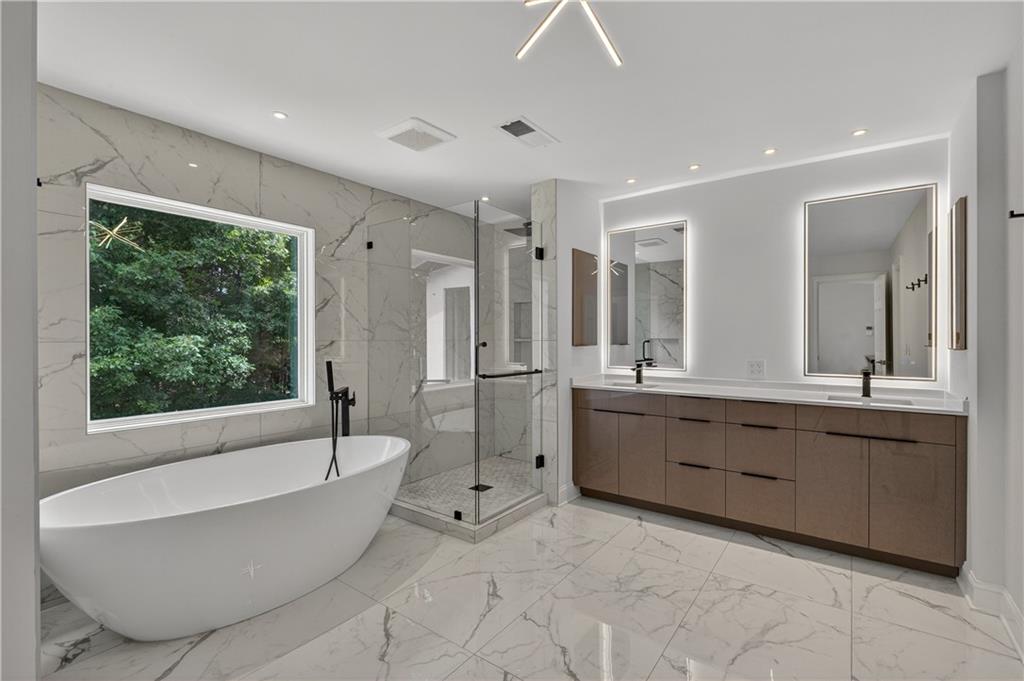 4610 West Morton Road Alpharetta, GA 30022 - Photo 31 of 53 a large bathroom with a large tub shower and sink