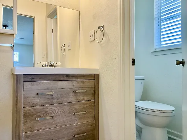 a bathroom with a sink a mirror and shower