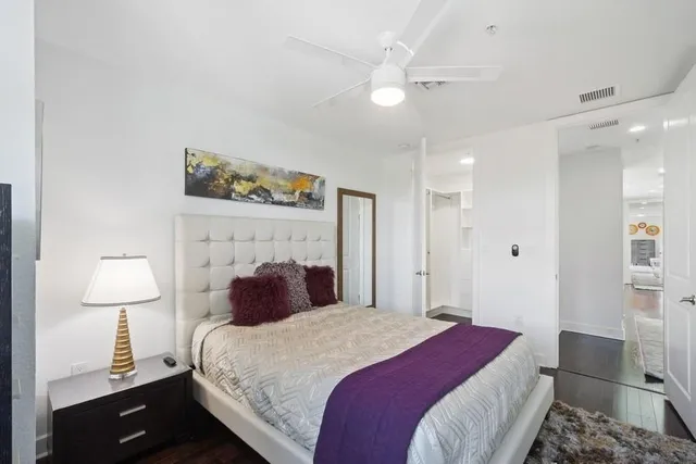 a bedroom with a bed and a lamp