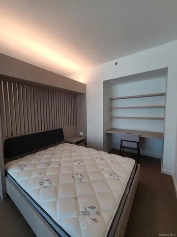 a bedroom with a bed and a night stand