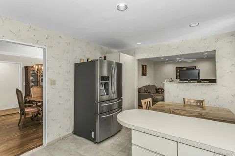 a kitchen with a refrigerator and a sink