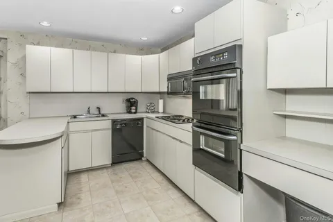 a kitchen with cabinets appliances and a sink
