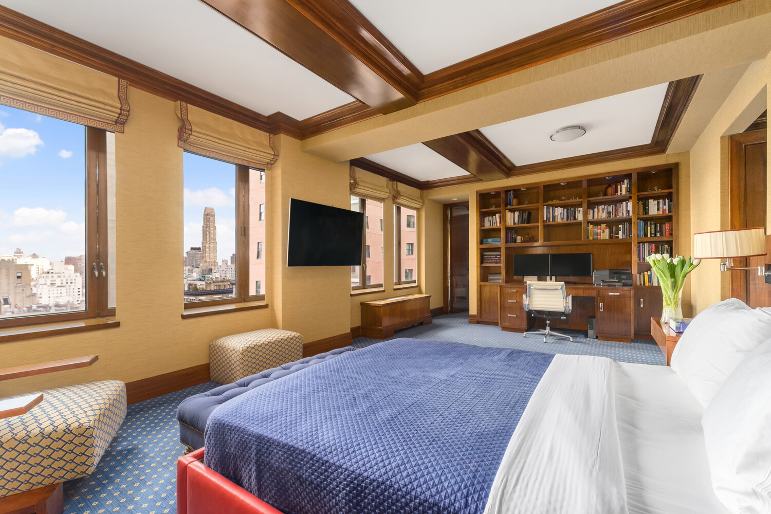 502 Park Avenue, Unit PH22 Manhattan, NY 10022 - Photo 17 of 19 a bedroom with furniture and a flat screen tv