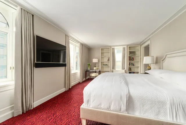 a bedroom with furniture and a flat screen tv