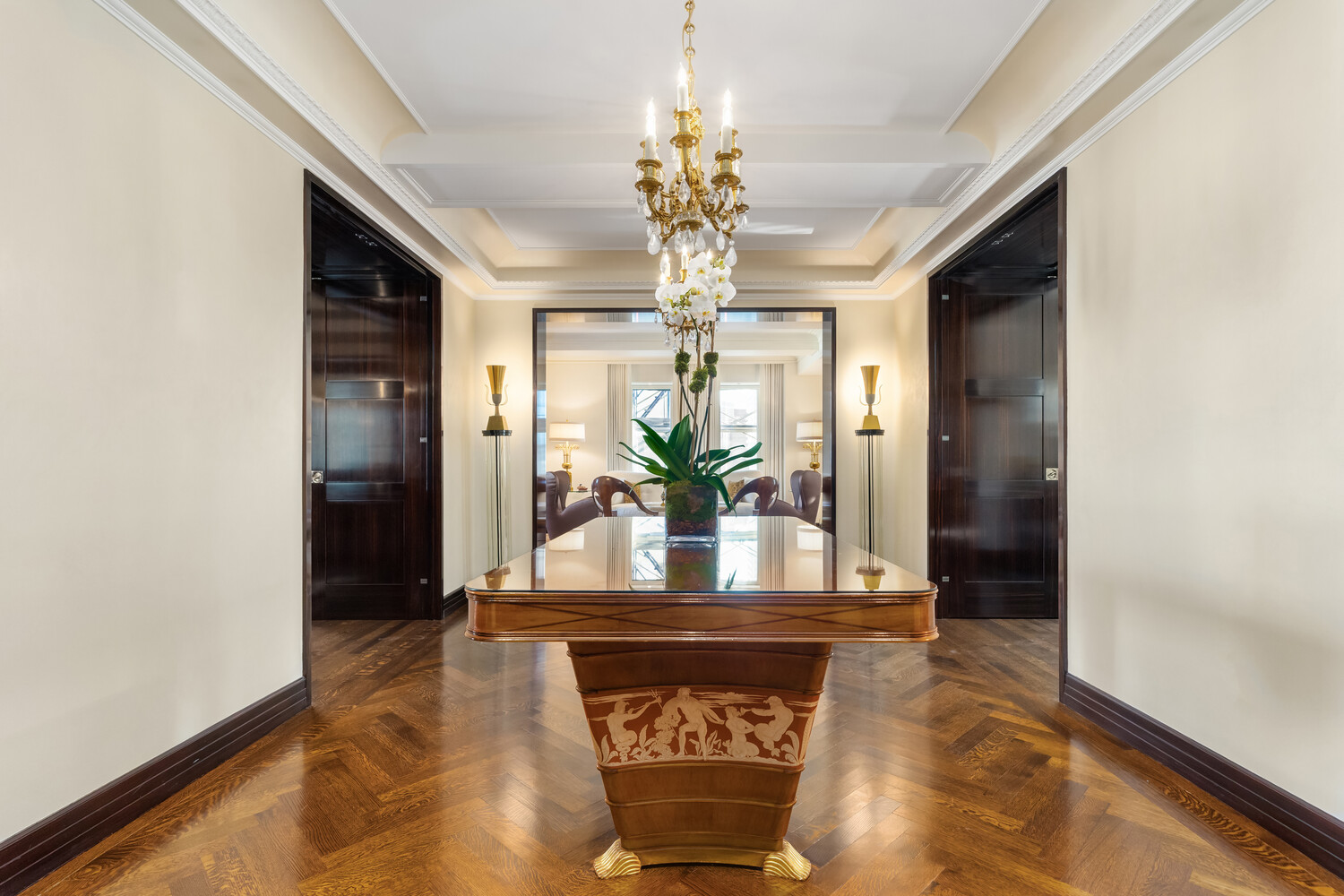 502 Park Avenue, Unit PH22 Manhattan, NY 10022 - Photo 2 of 19 a view of a hallway with wooden floor and a chandelier