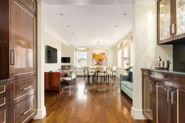 a view of a dining room with furniture and a chandelier