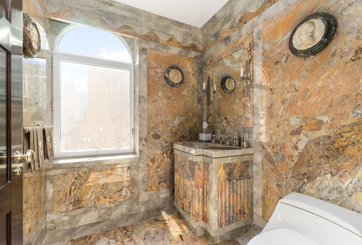 502 Park Avenue, Unit PH22 Manhattan, NY 10022 - Photo 9 of 19 a bathroom with a granite countertop sink a mirror and a shower